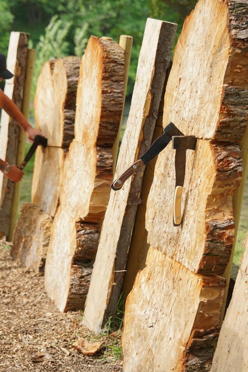 a wooden fence with a bunch of logs