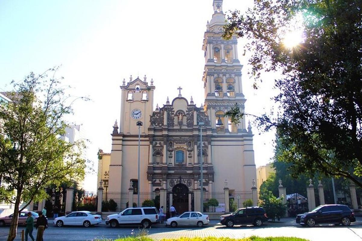 a building with a clock tower and cars parked in front of it