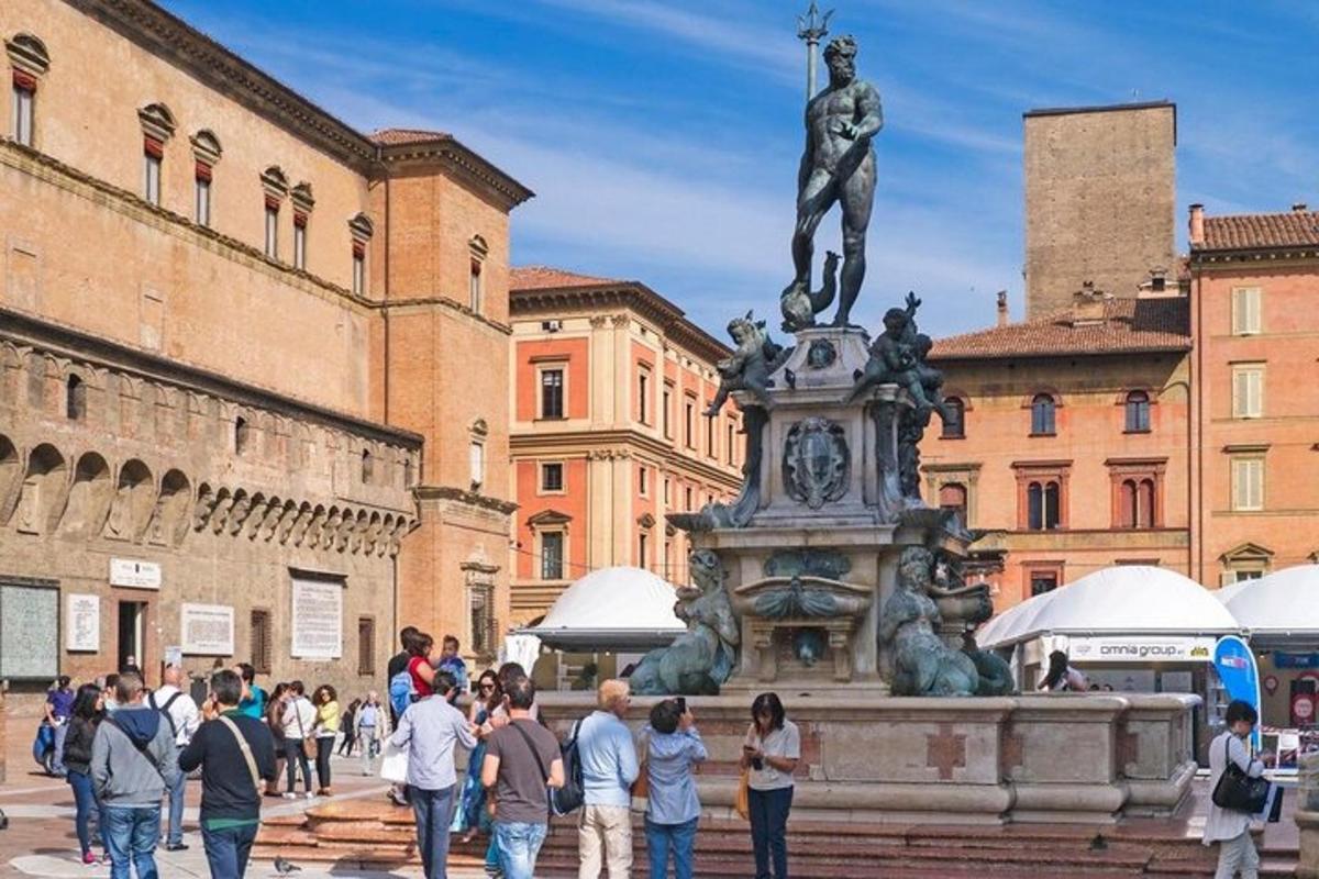 a group of people walking around a statue in a city