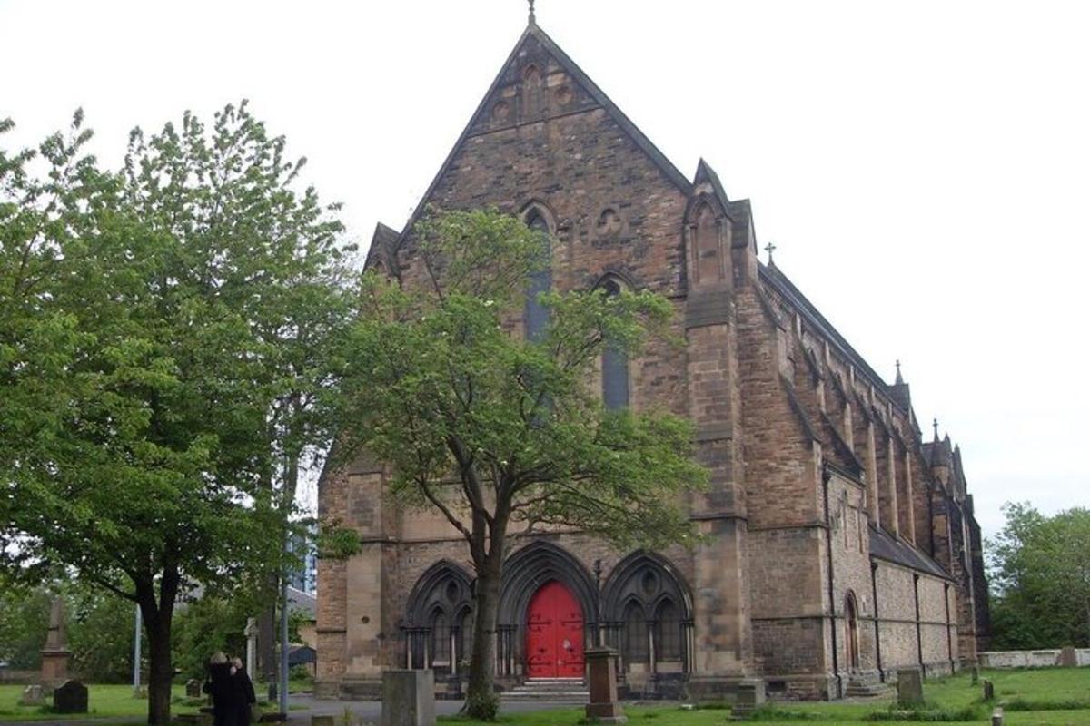 an old stone church with a red door