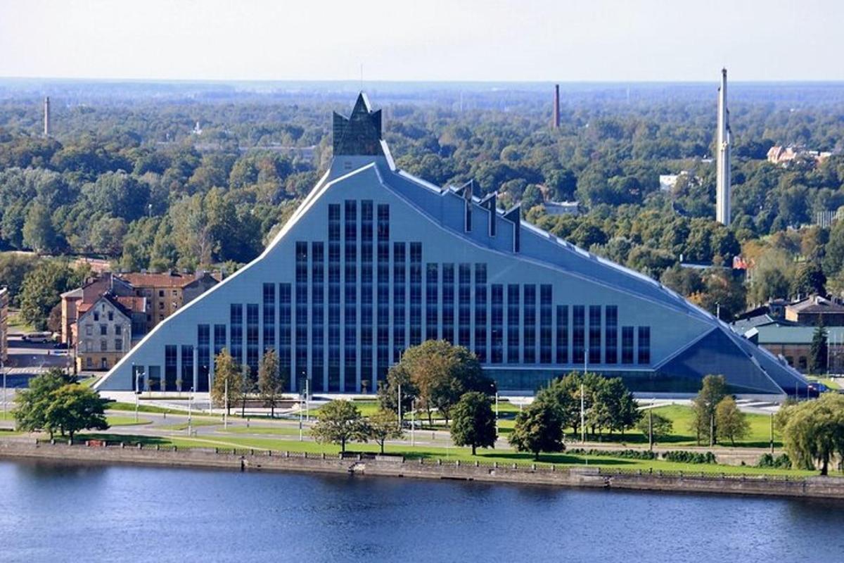 a large building with a pointed roof on top of a lake