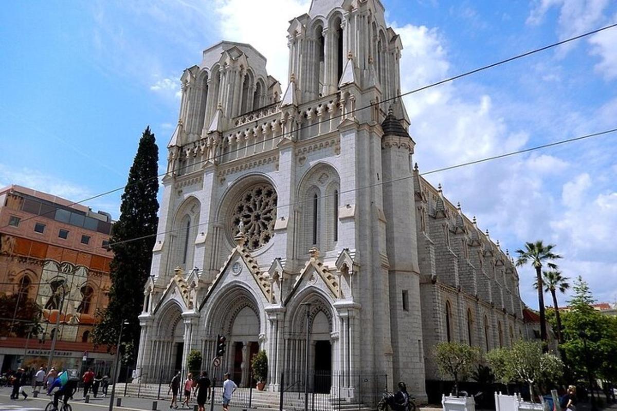 a large white church with people walking in front of it