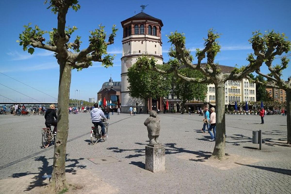 a group of people riding bikes in front of a clock tower