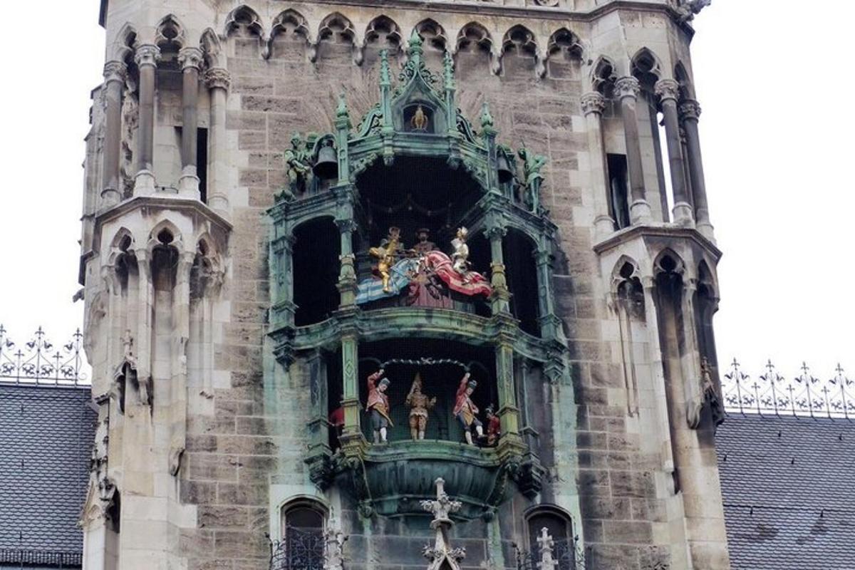 a building with a bell tower with figurines on it