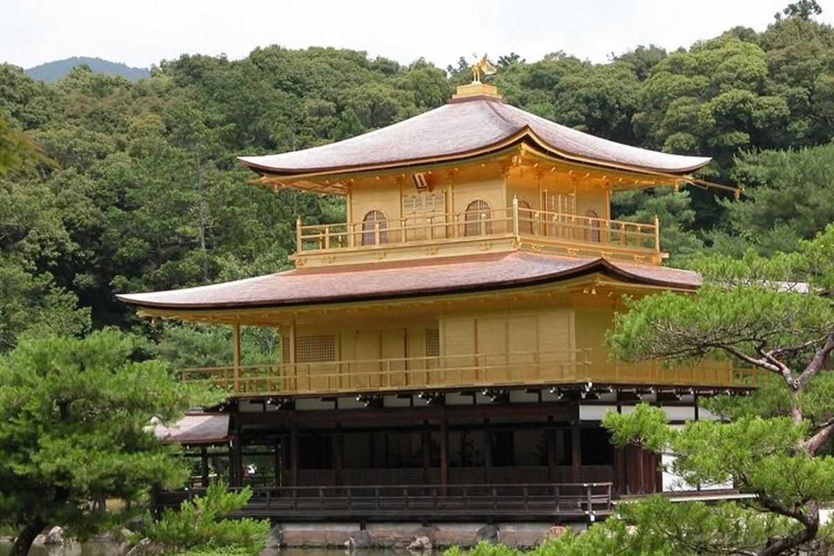 a large yellow building with a roof on a mountain