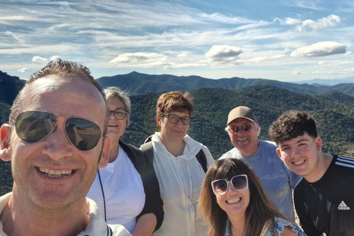 a group of people posing for a picture in the mountains