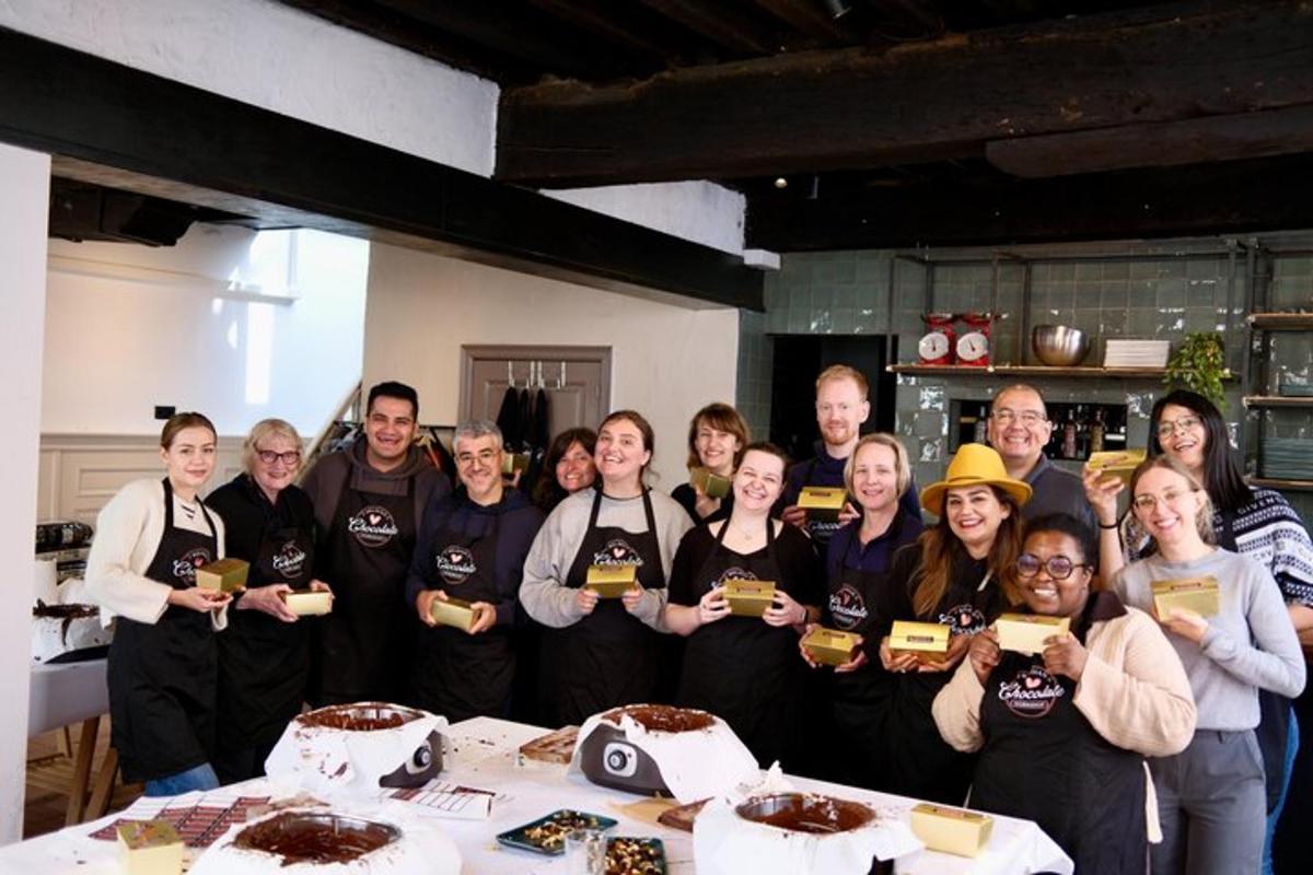 a group of people standing around a table with cakes