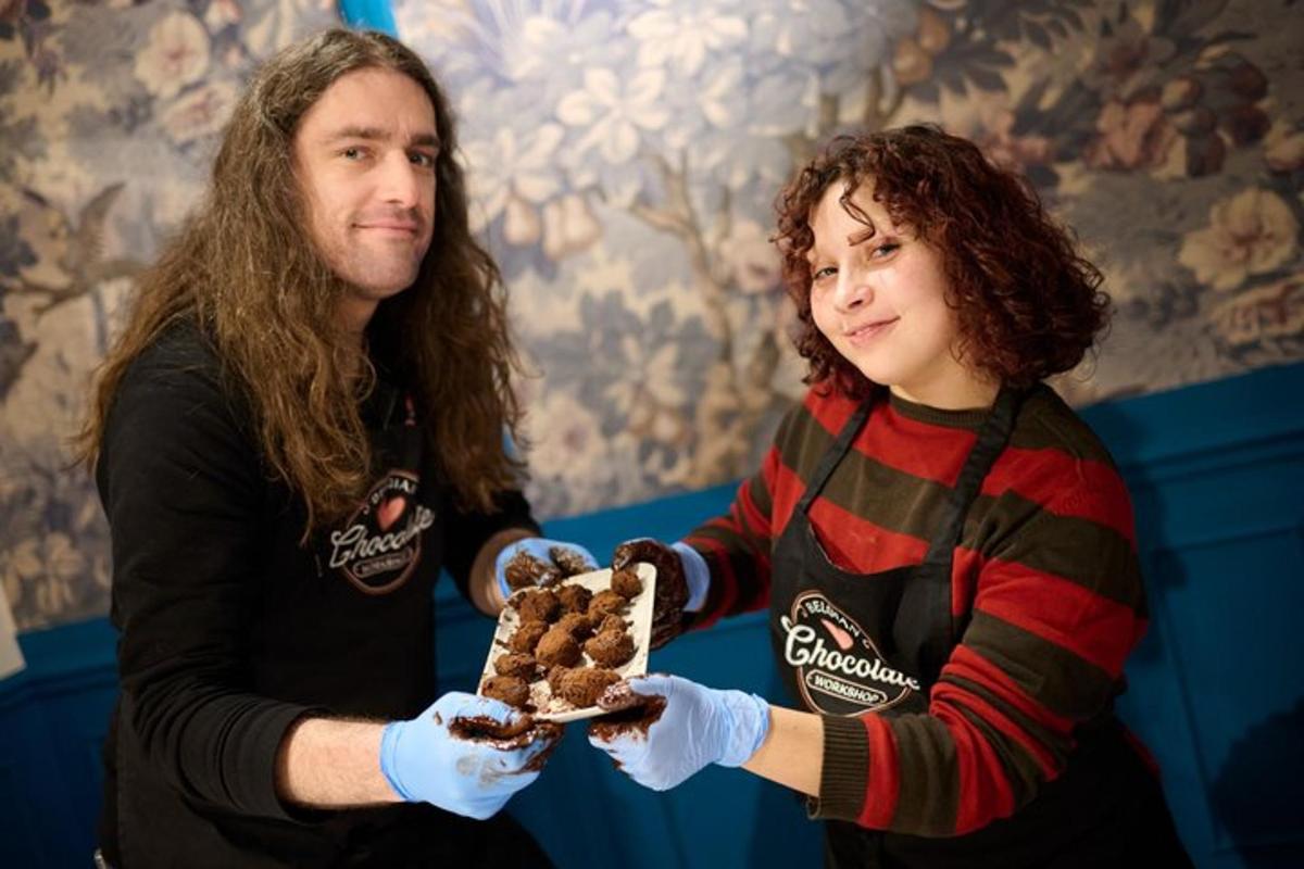 a man and a woman holding a piece of cake