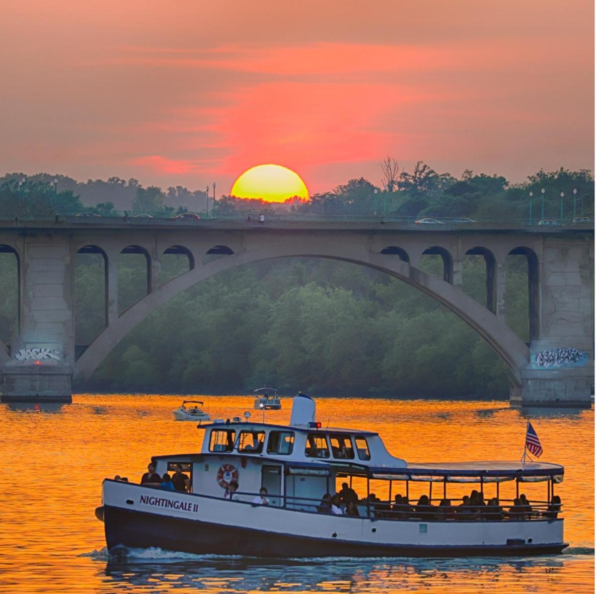 a boat on the water under a bridge