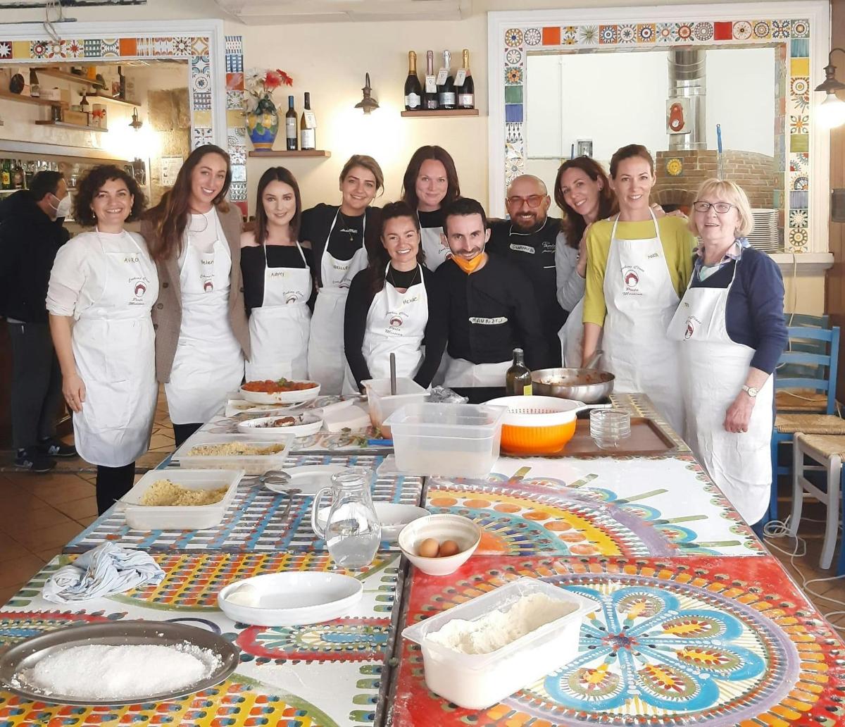 a group of people in a kitchen preparing food