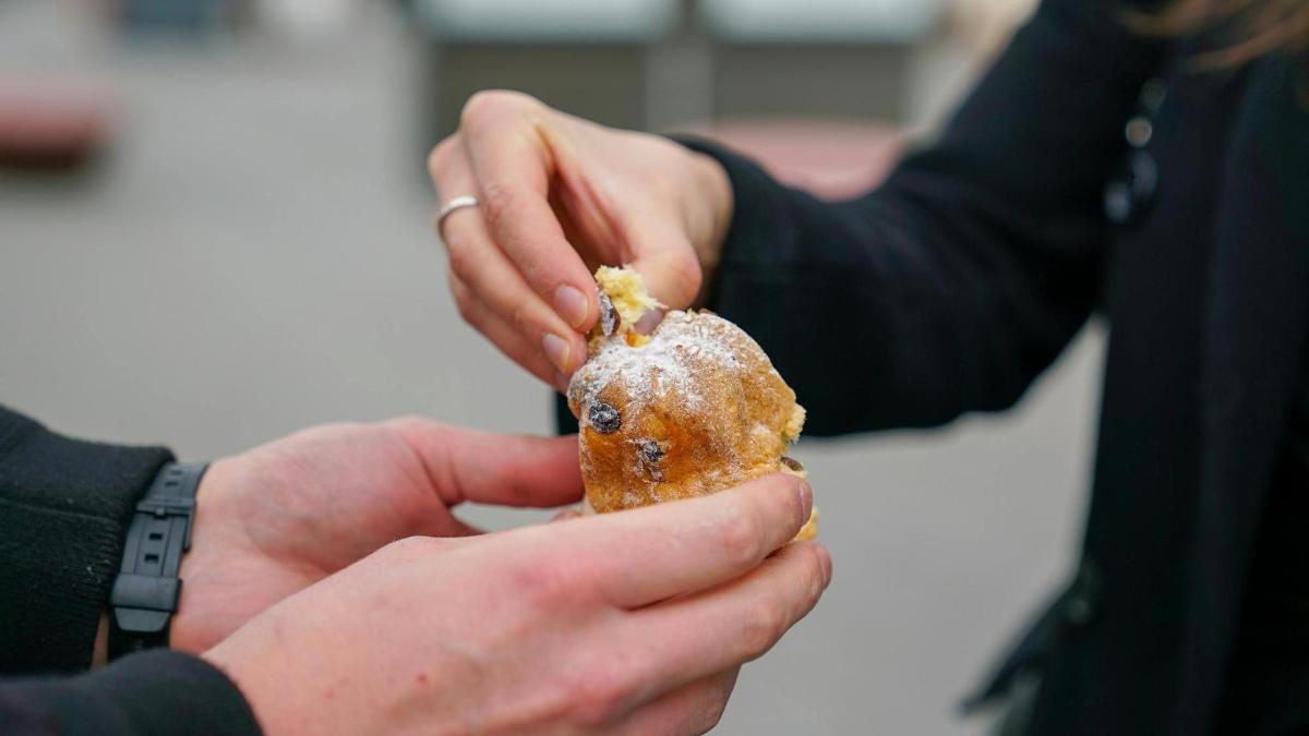 a person holding a piece of food in their hands