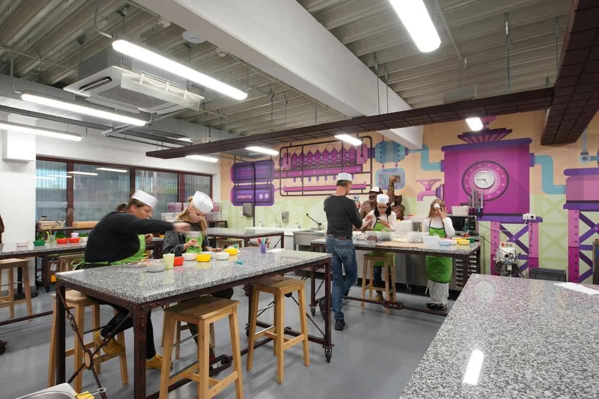 a group of people in a kitchen preparing food