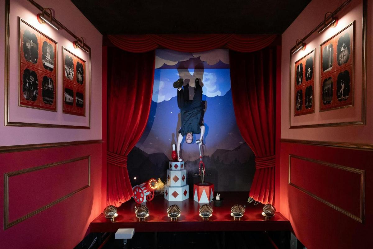 a room with red curtains and a painting on the wall