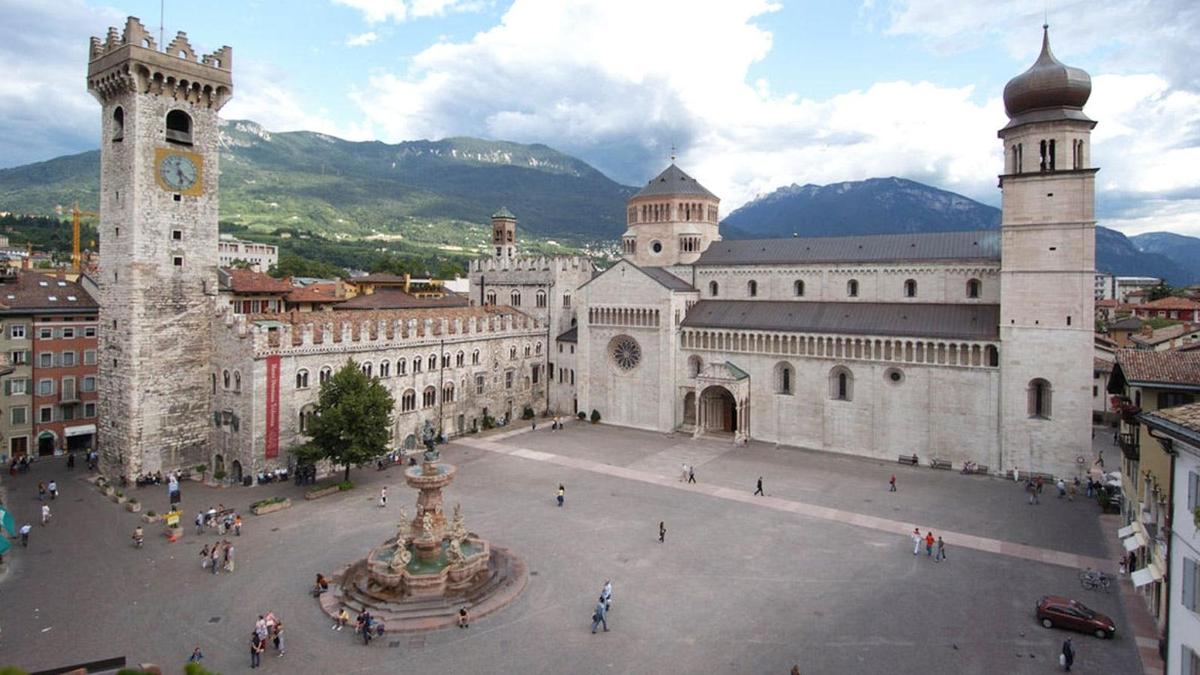 a large building with a clock tower and a fountain