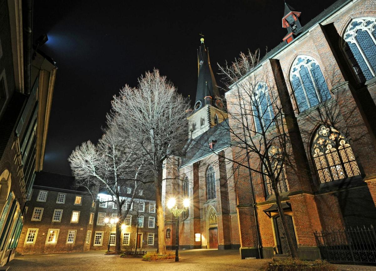 a large building with a church at night