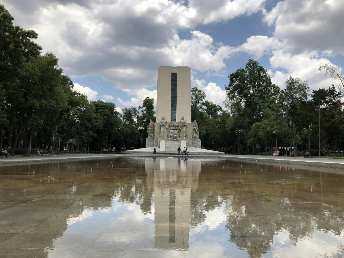 a monument with a reflection in a pool of water