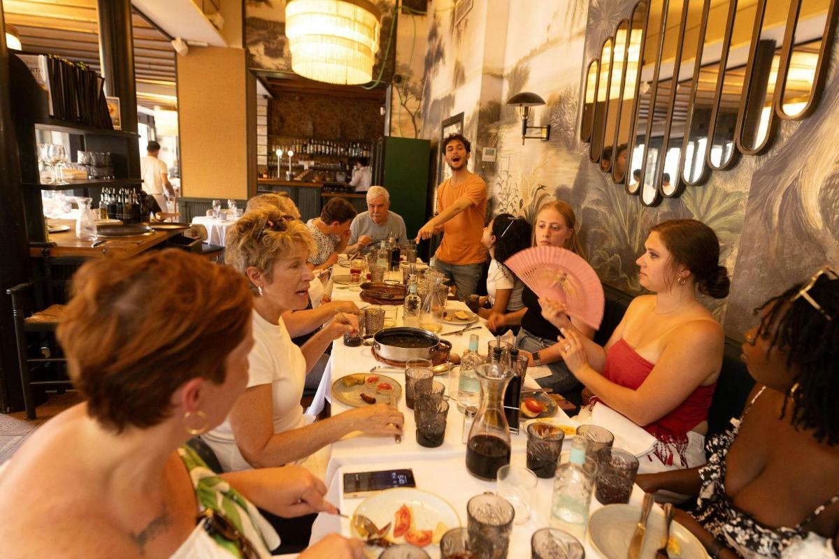 a group of people sitting at a table eating