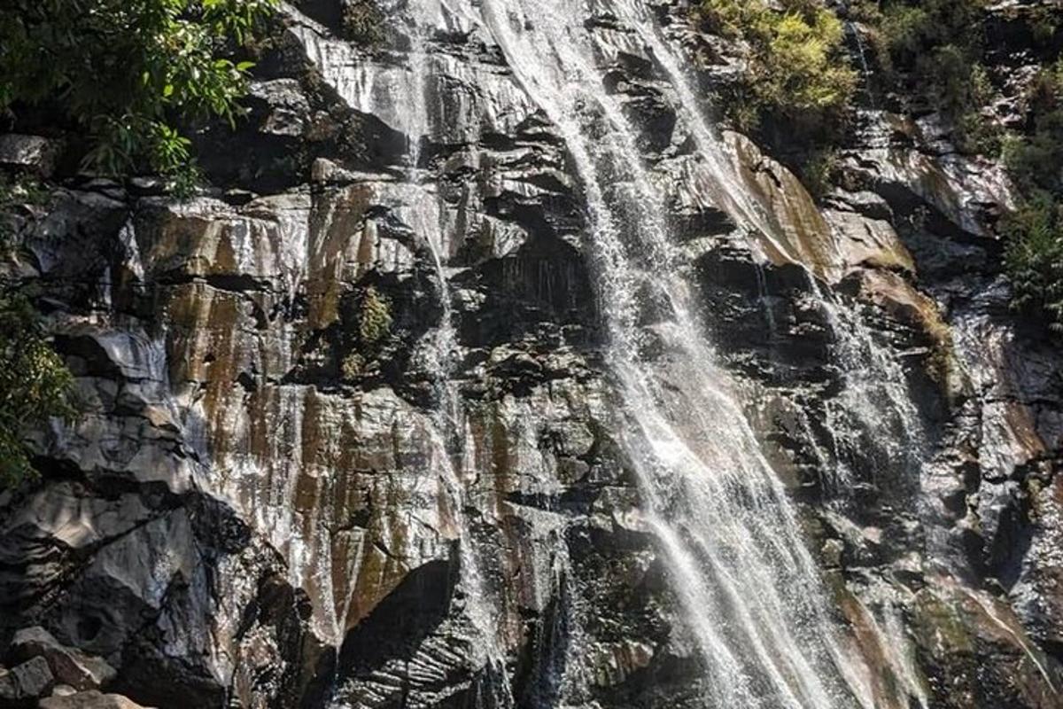 a waterfall on the side of a rocky mountain