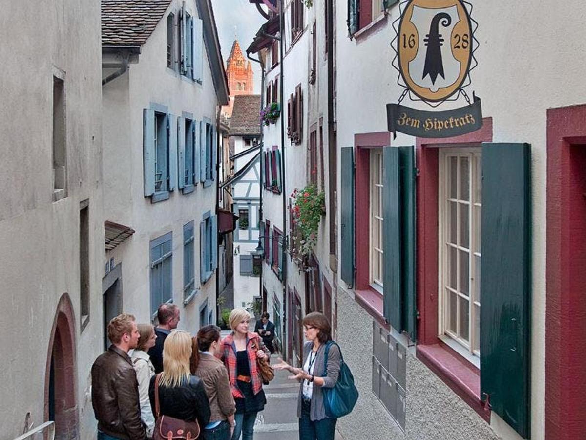 a group of people walking down a narrow street
