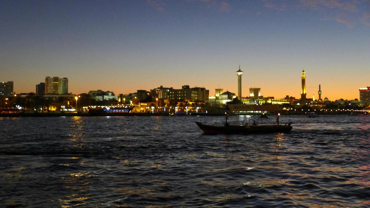 a boat in the water with a city in the background