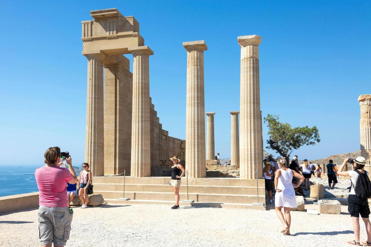 a group of people standing in front of a monument