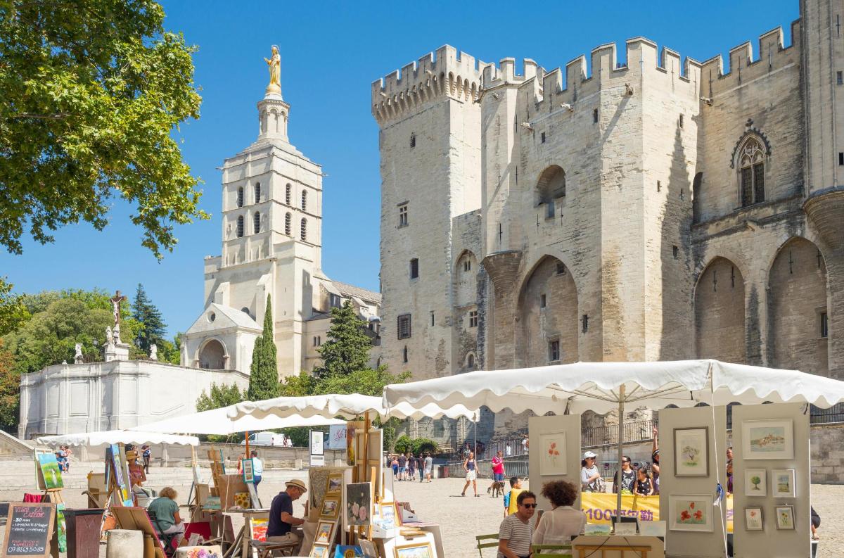 people sitting at tables in front of a castle