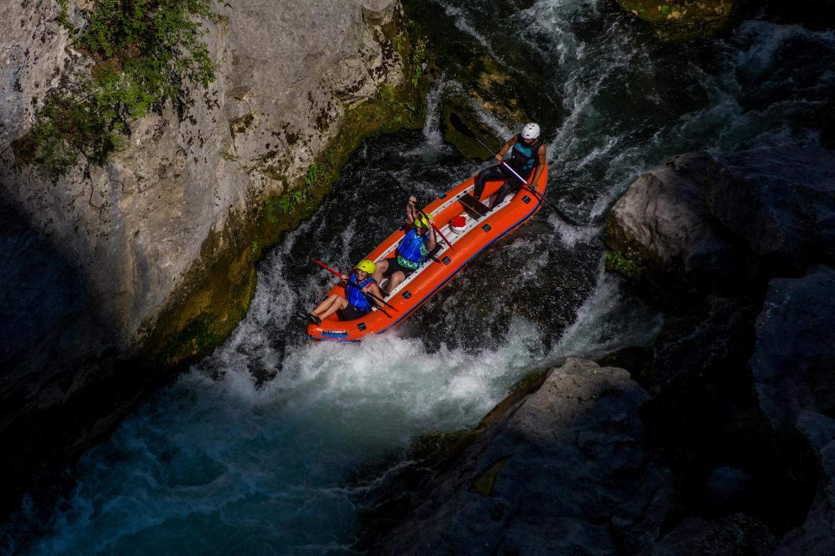 a group of people in a raft in a river
