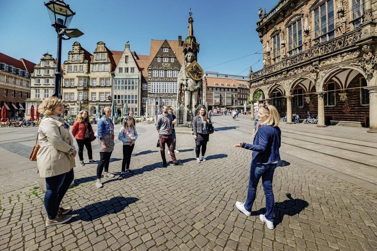 a group of people standing on a street in a city
