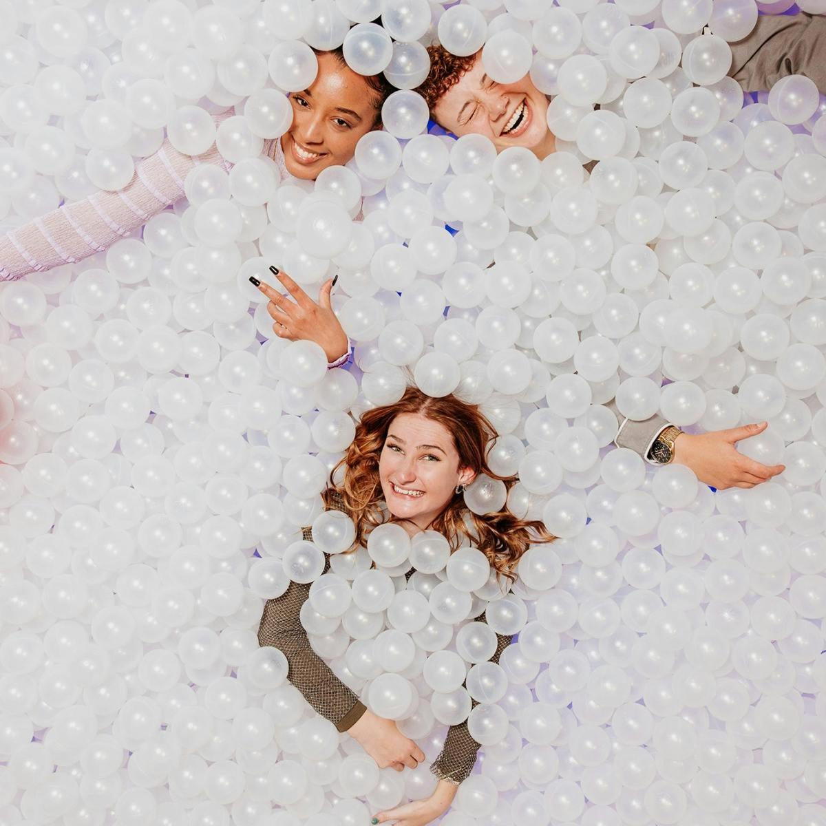 a group of people in a wall of balls