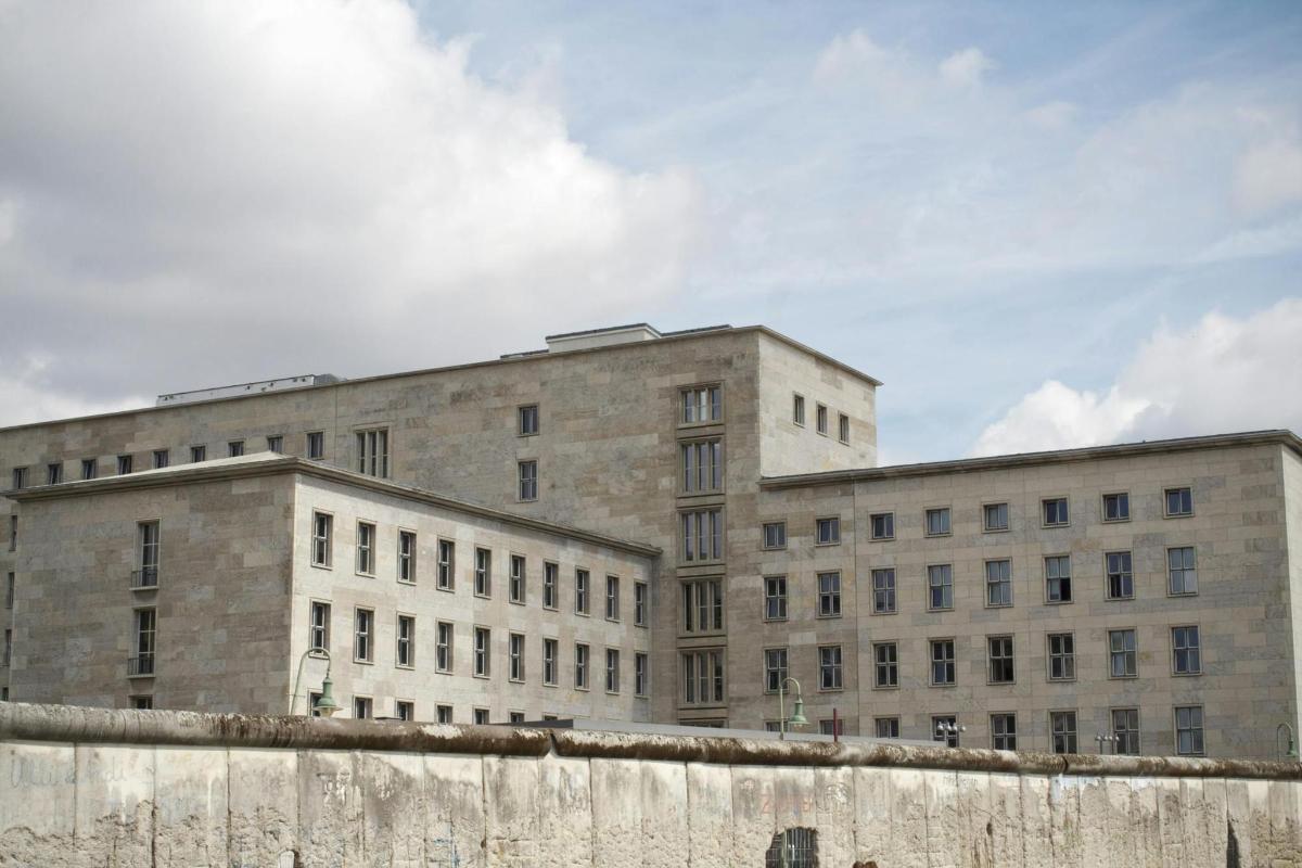 a large stone building with a fence in front of it