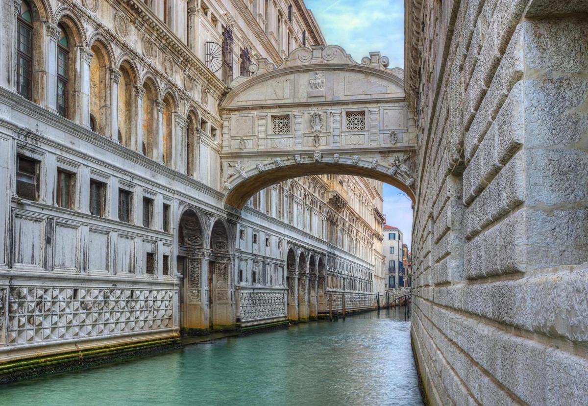 a bridge over a canal in a building with water