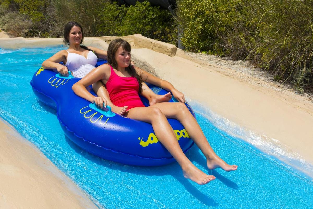 two women are riding on an inflatable