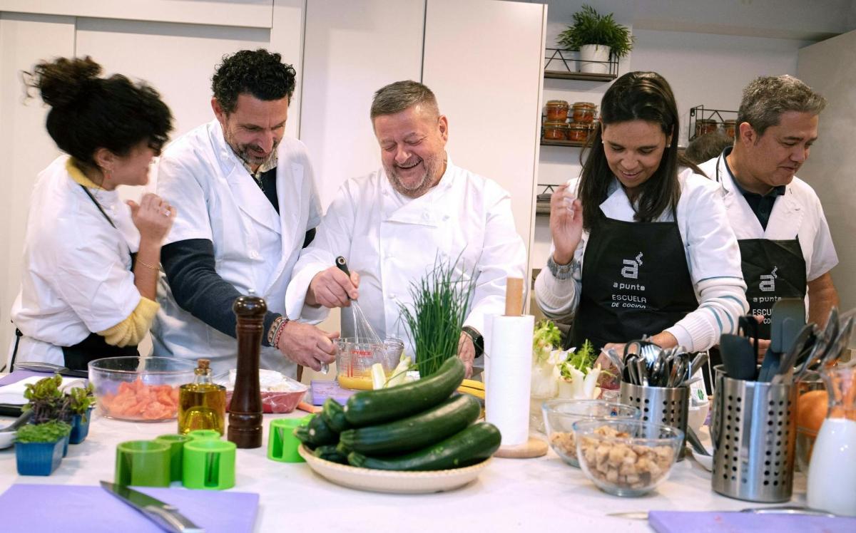 a group of people in a kitchen preparing food