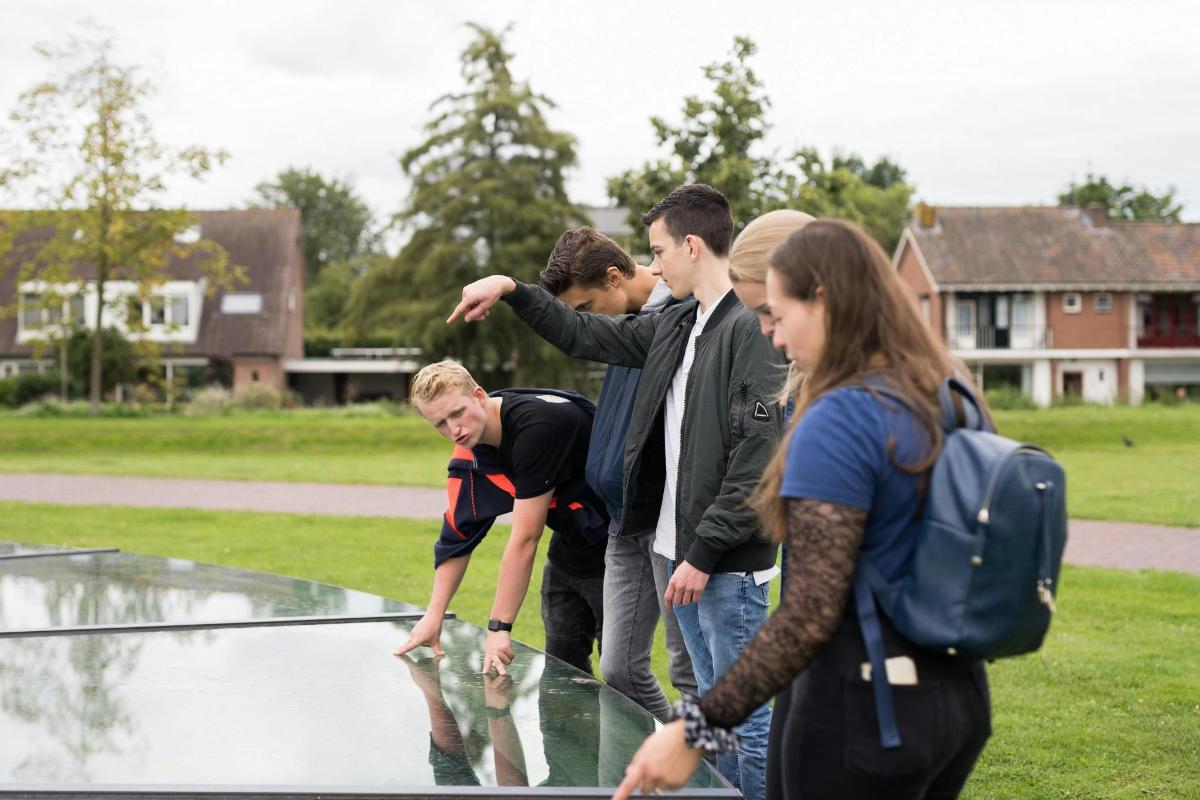 a group of people standing around a fountain