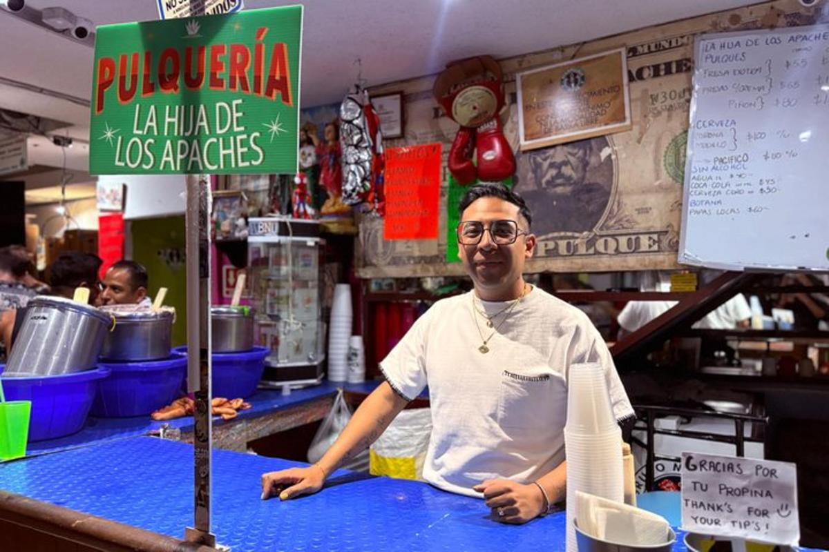 a man is sitting at a counter in a restaurant