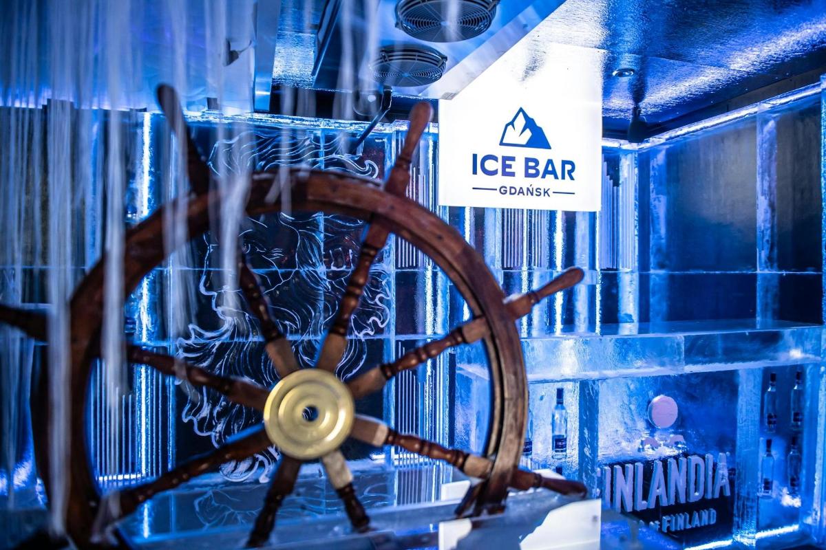 a wooden steering wheel in a room with a ice bar sign