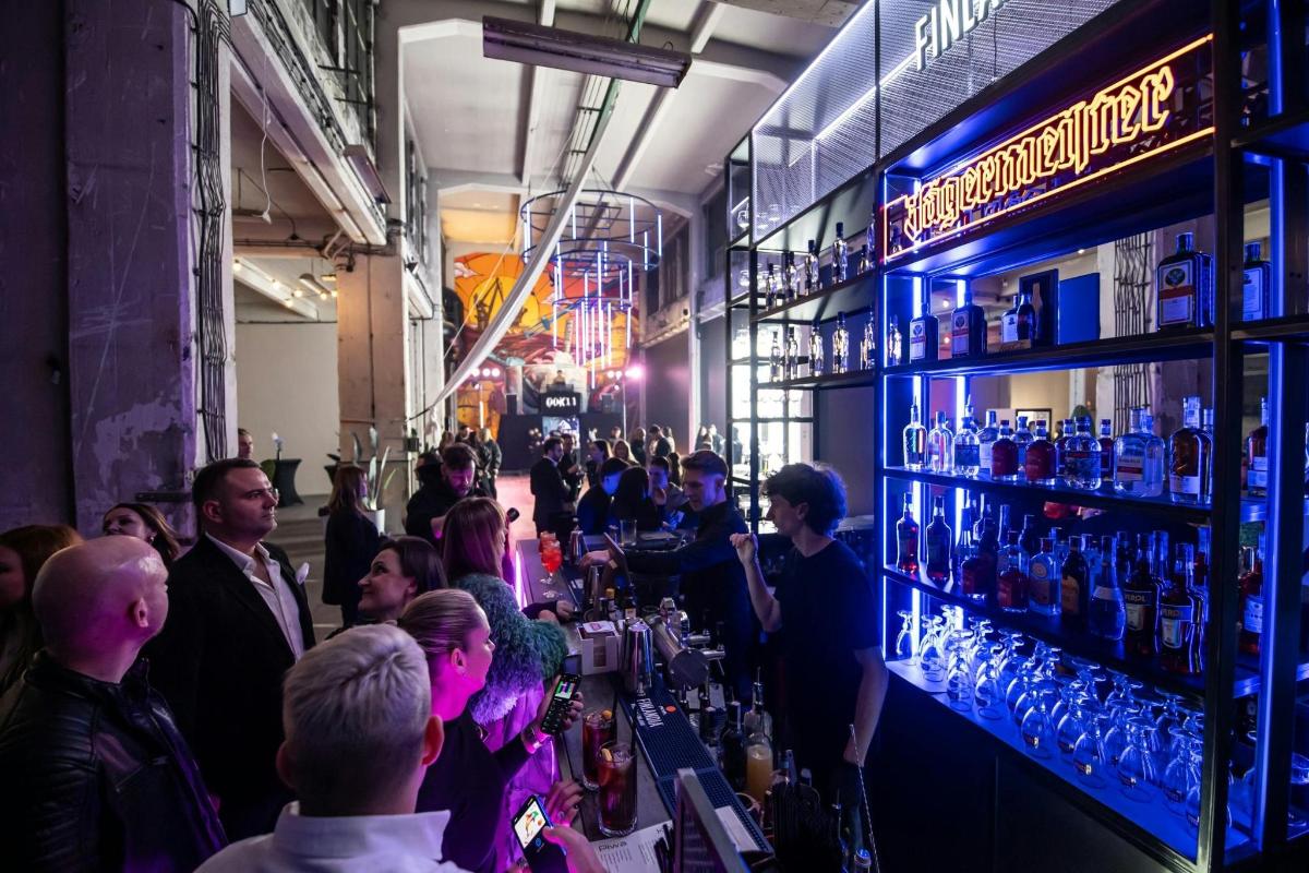 a group of people standing at a bar