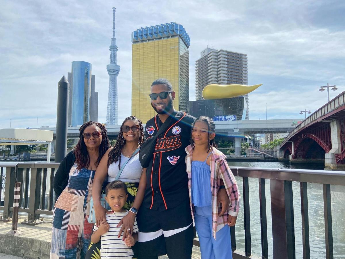 a man and his family posing for a picture on a bridge