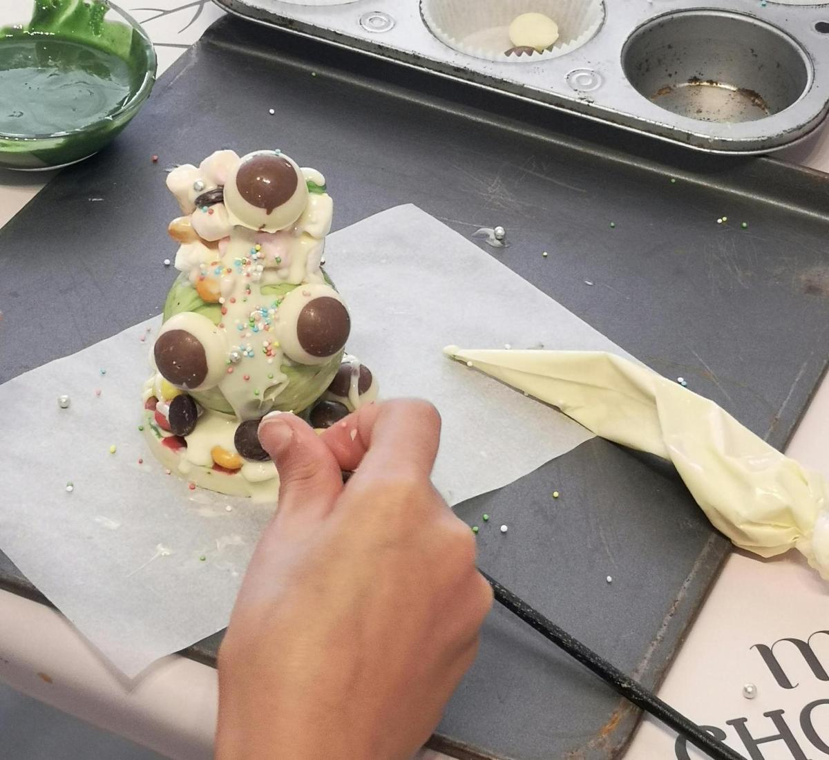 a person is making a dessert on a table