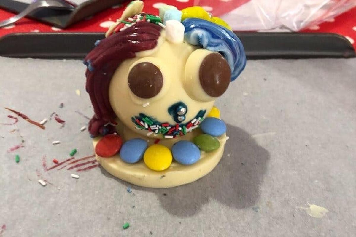 a small figurine of a toy dog with candy on it
