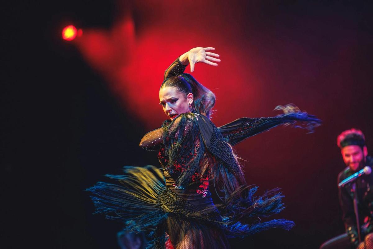 a woman performing a dance on a stage