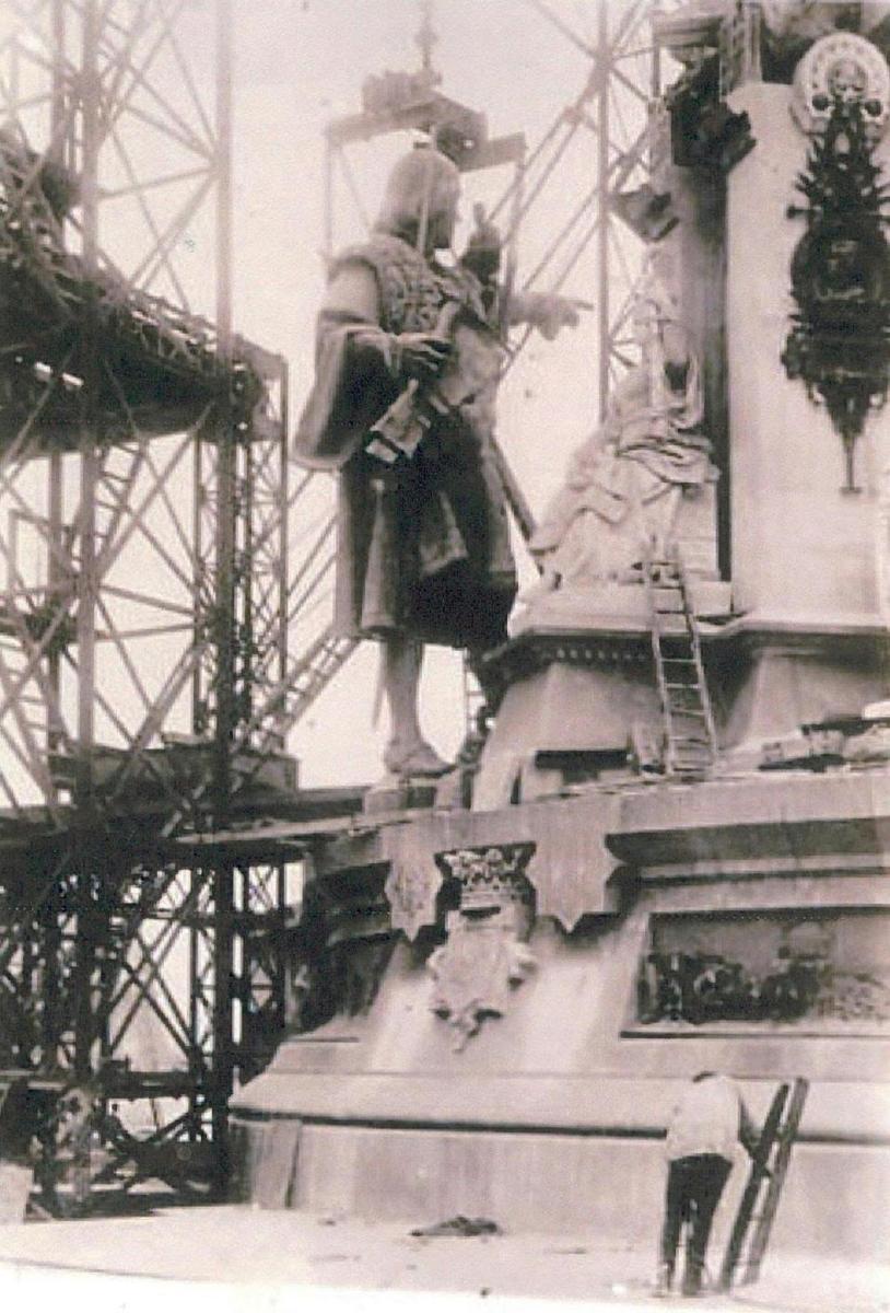 a man standing in front of a statue on a fountain