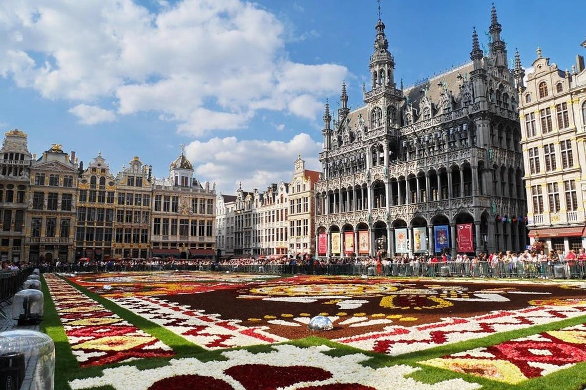 a large building with a flower maze in front of it