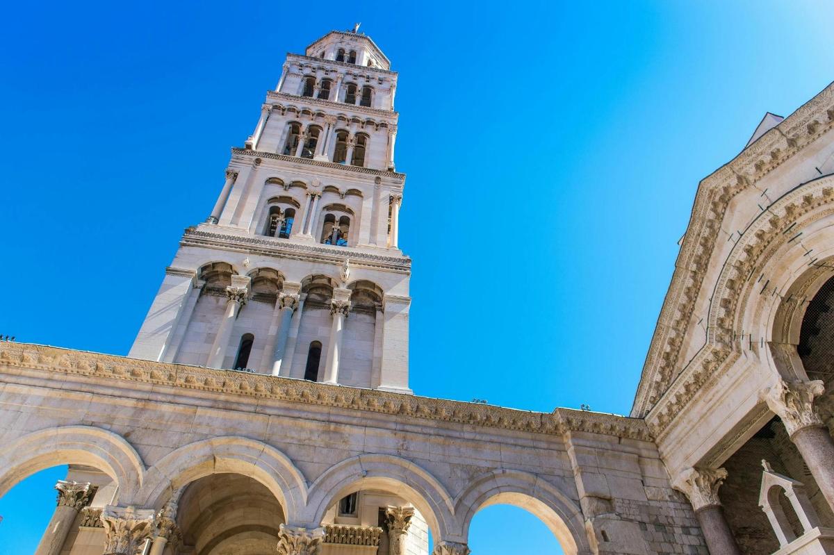 a tall building with a clock tower in the background