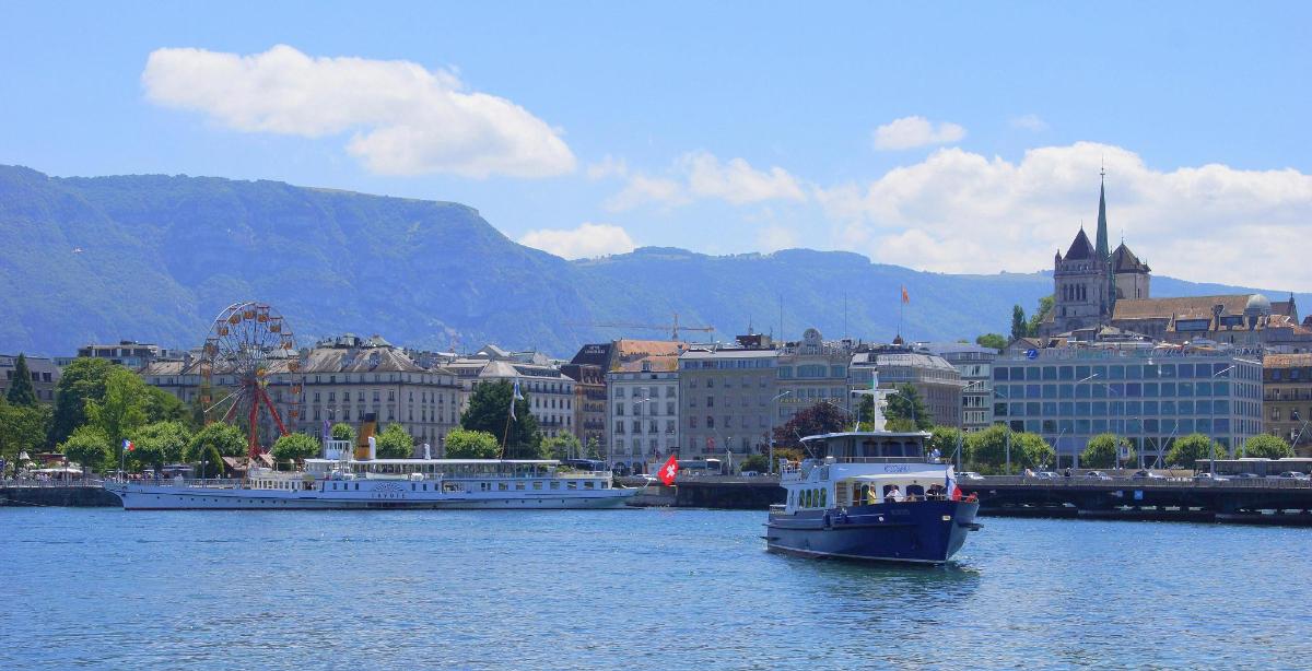 a boat in the water with a city in the background