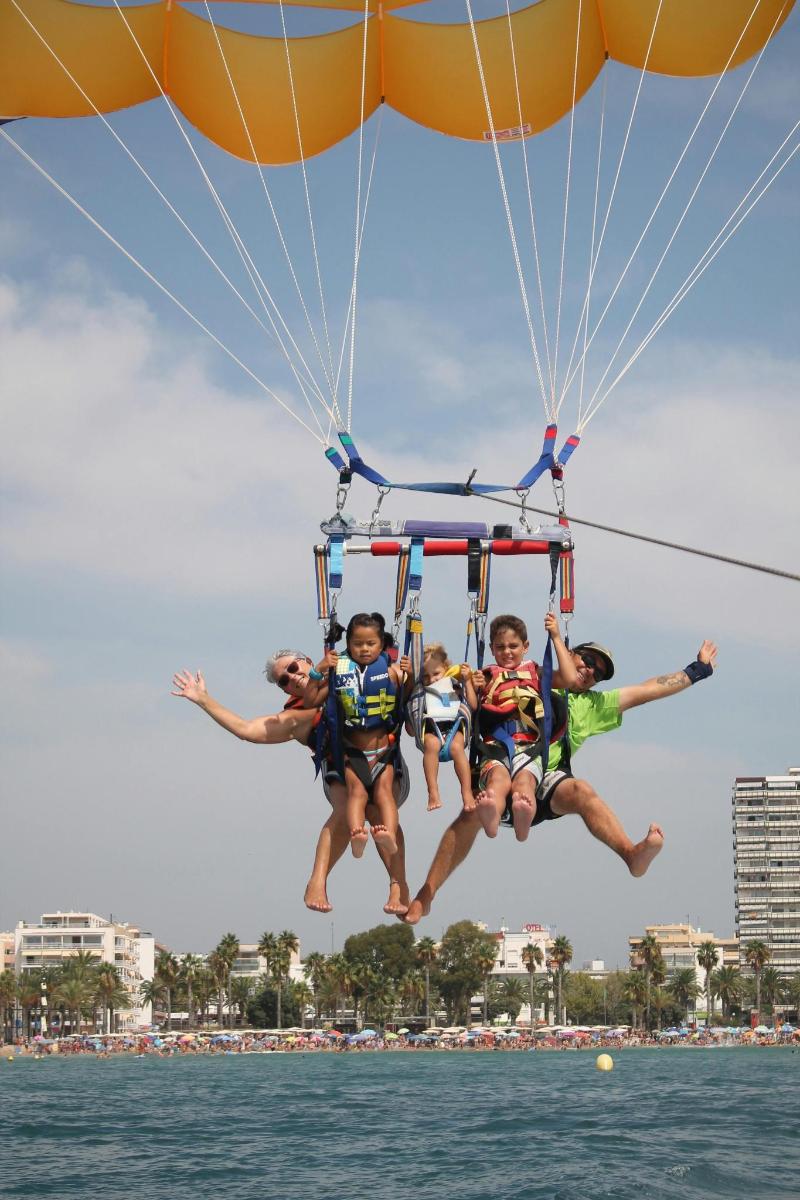 a group of kids jumping off a parachute
