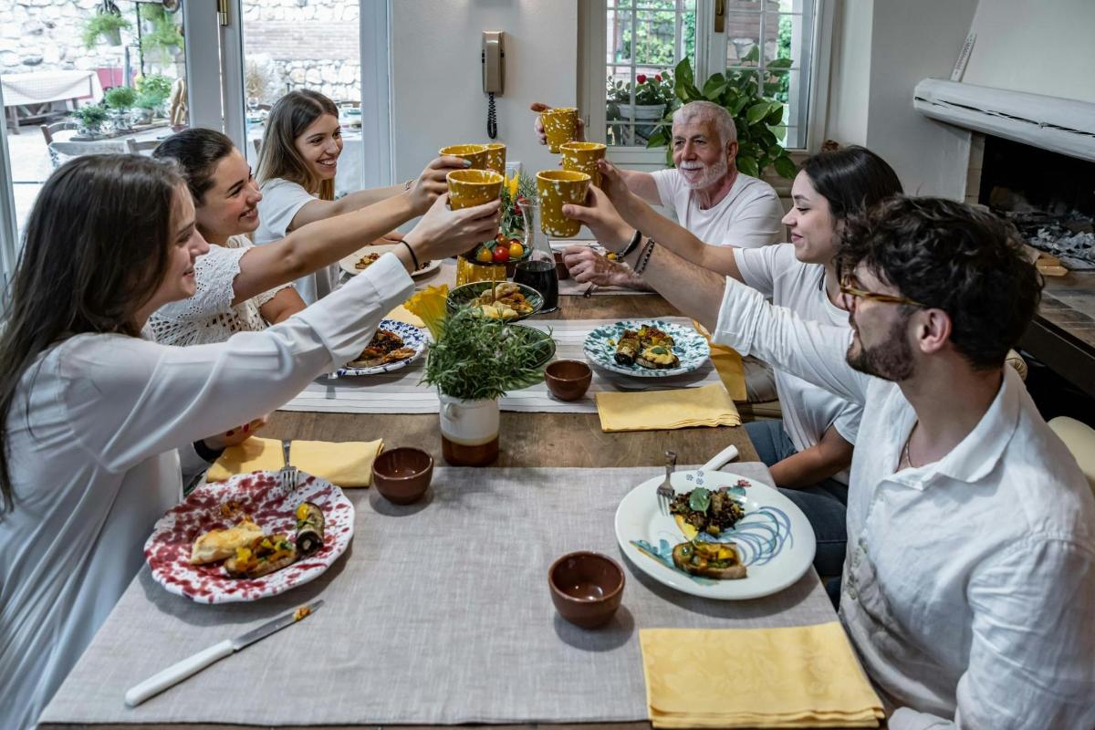 a group of people sitting around a table drinking beer
