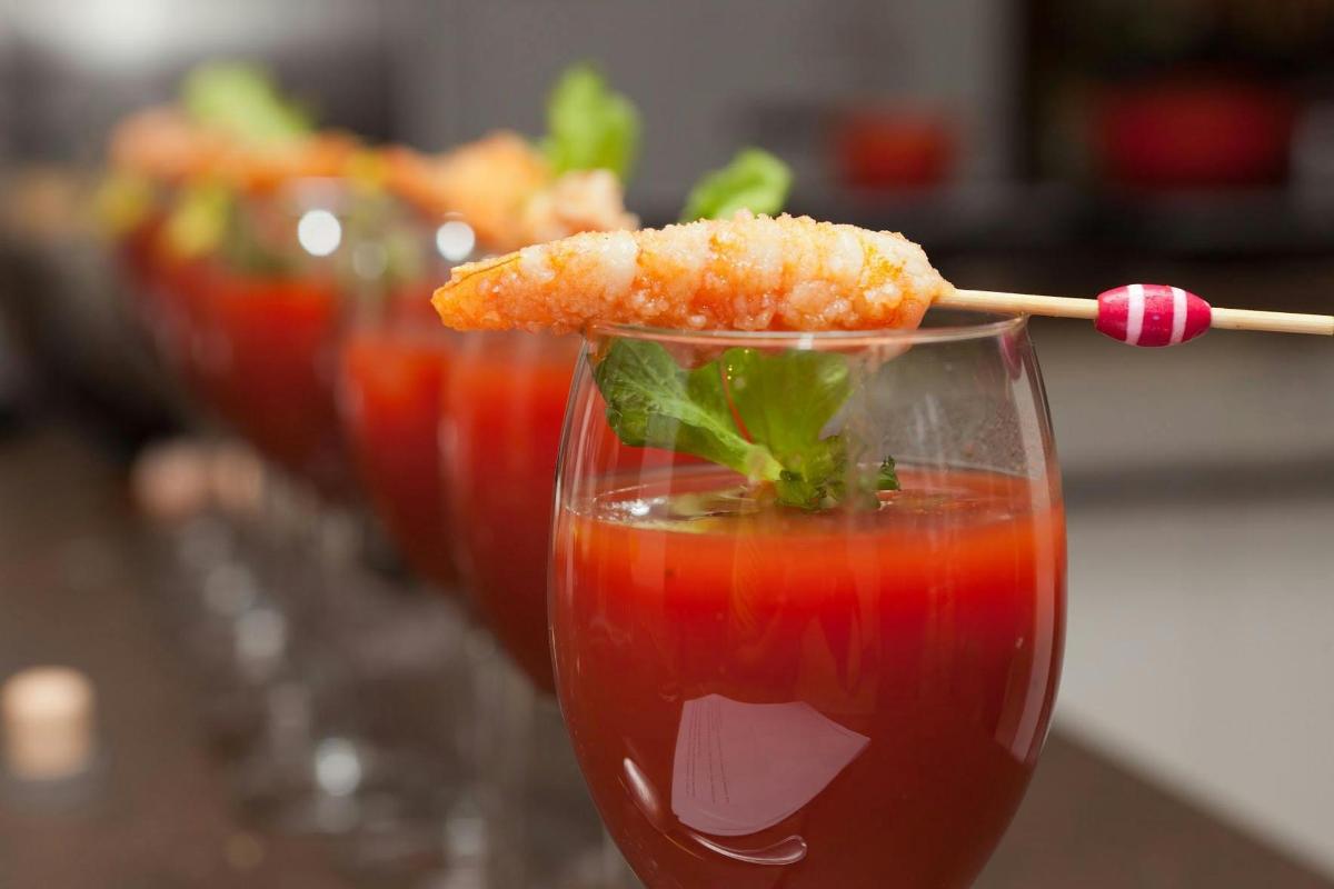 a row of glasses with a drink with a stick in it