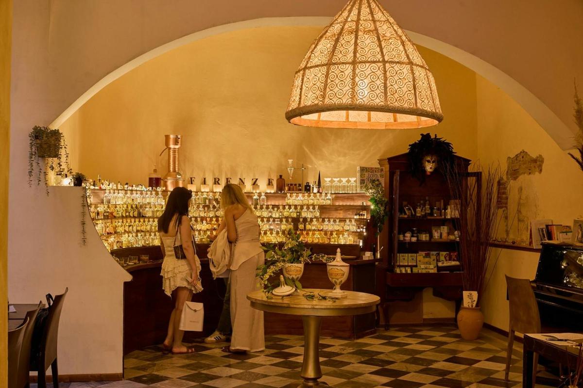 two women standing in a wine tasting room