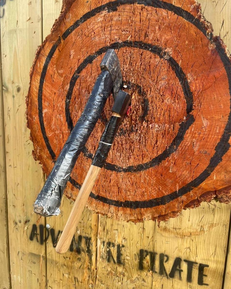 a pair of axes sitting on top of a log